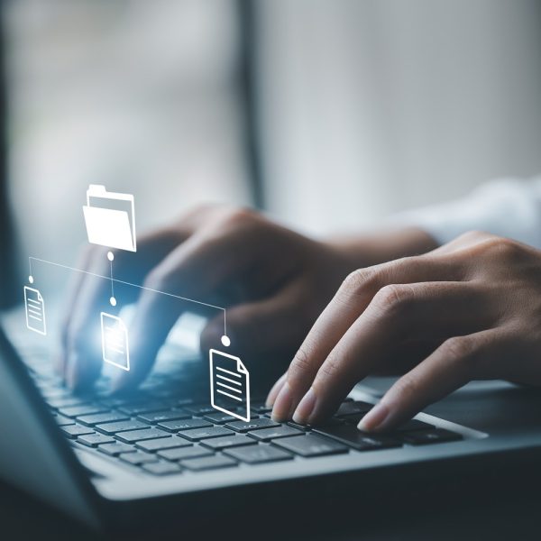 business man typing on a keyboard with holograms of digital document files, data files on computers stored as cloud databases can be viewed online and prevented data loss from the device.